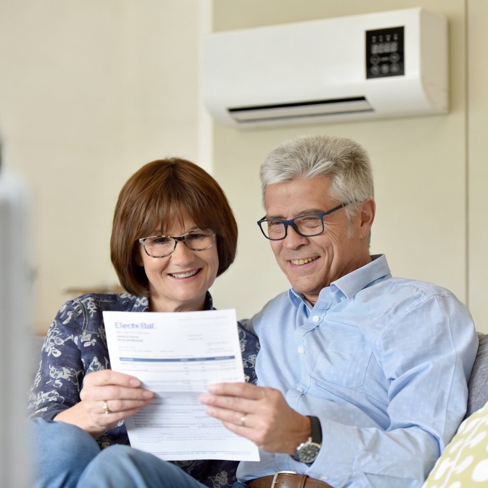 A couple looking over household paperwork at home