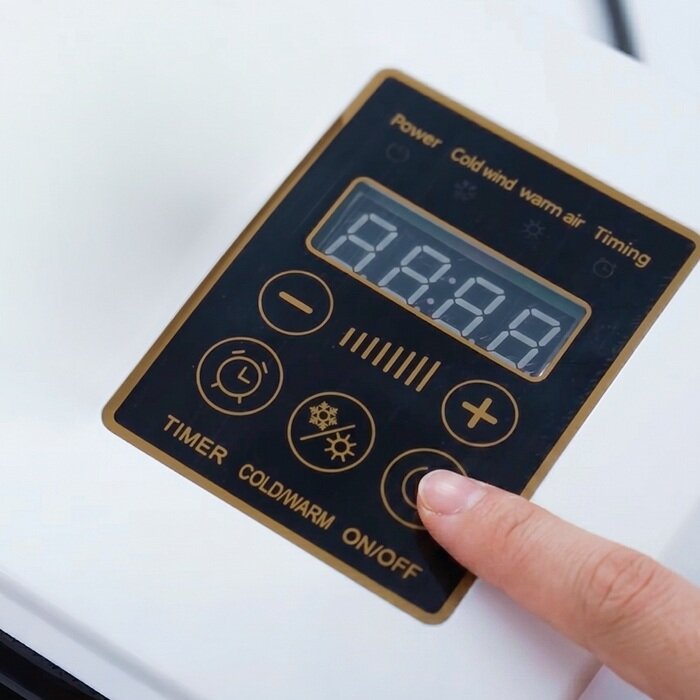 A hand selecting a mode on the BlizzAir remote control